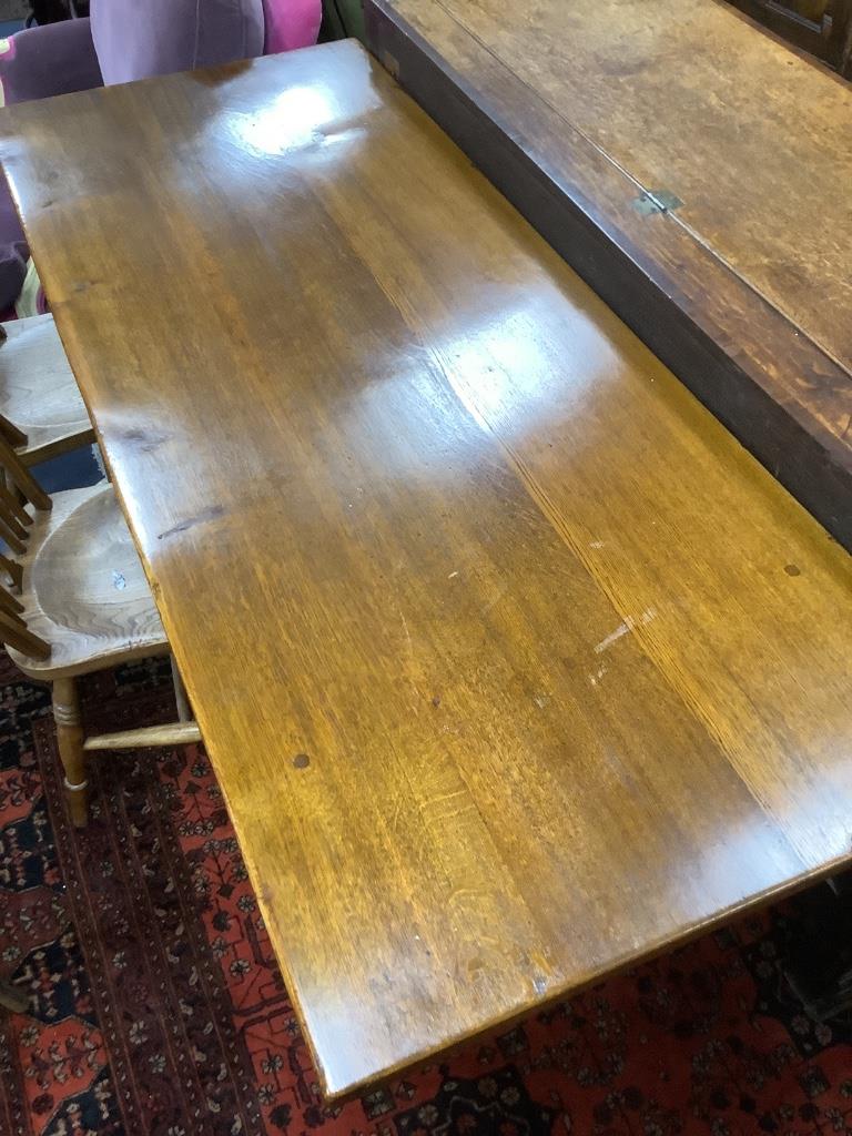 A modern kitchen refectory table, and three wheel back dining chairs (4)